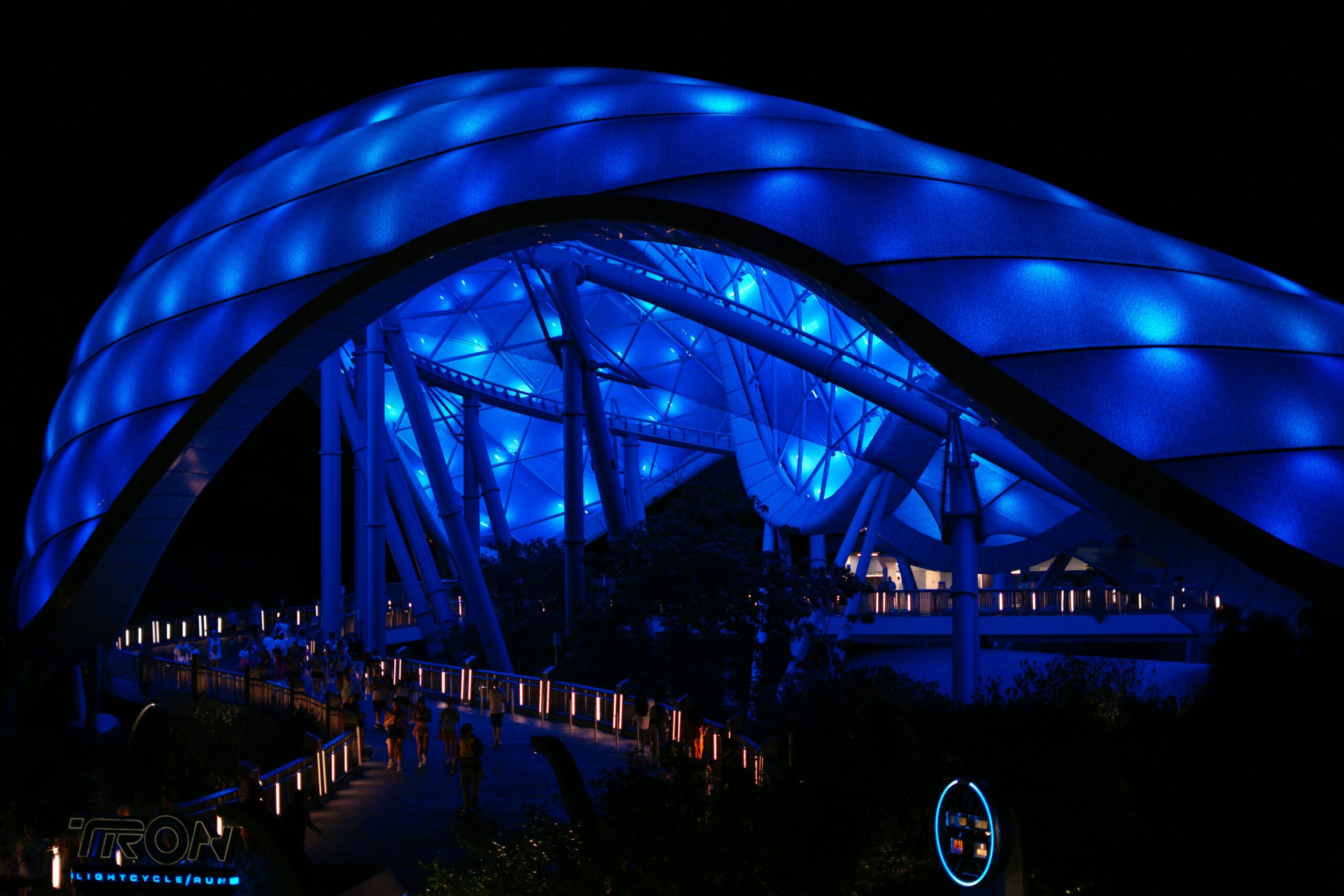 TRON Lightcycle Run canopy lit blue at night, Magic Kingdom