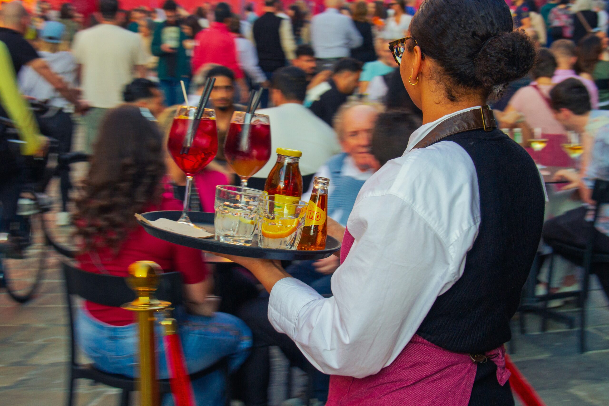 Waiter carrying a tray of drinks in a restaurant