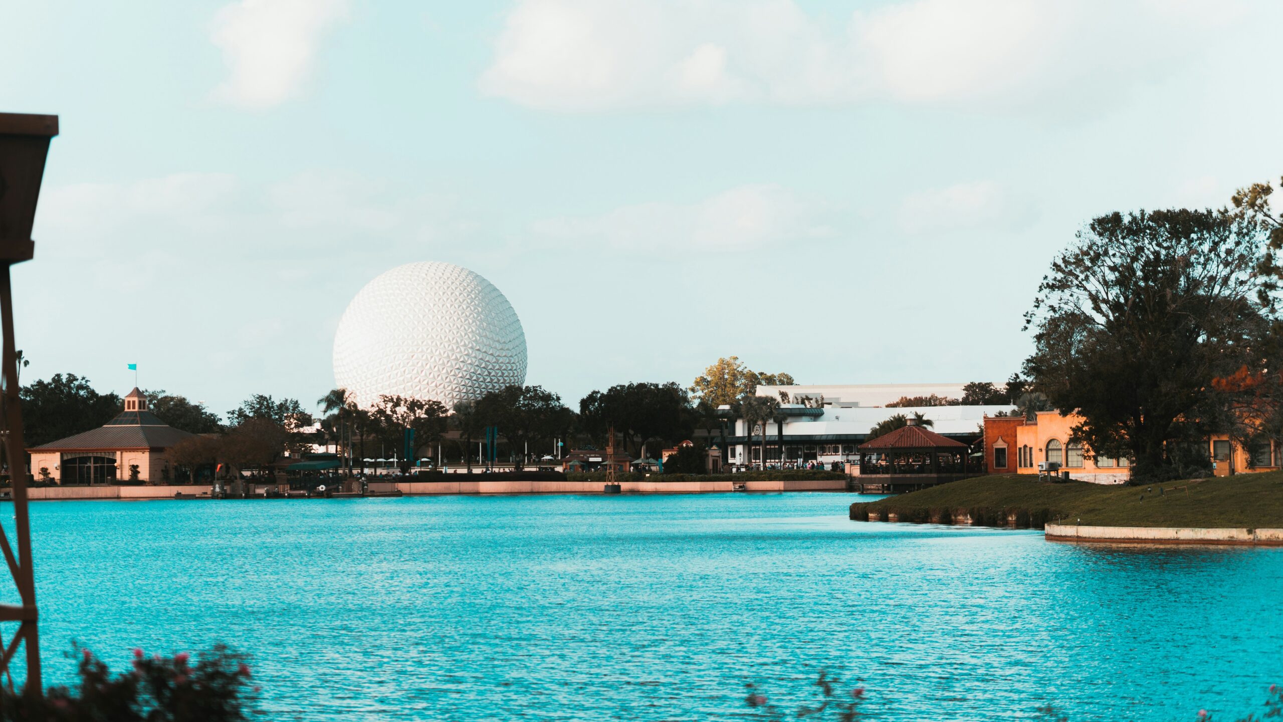A resort pool with Spaceship Earth beyond
