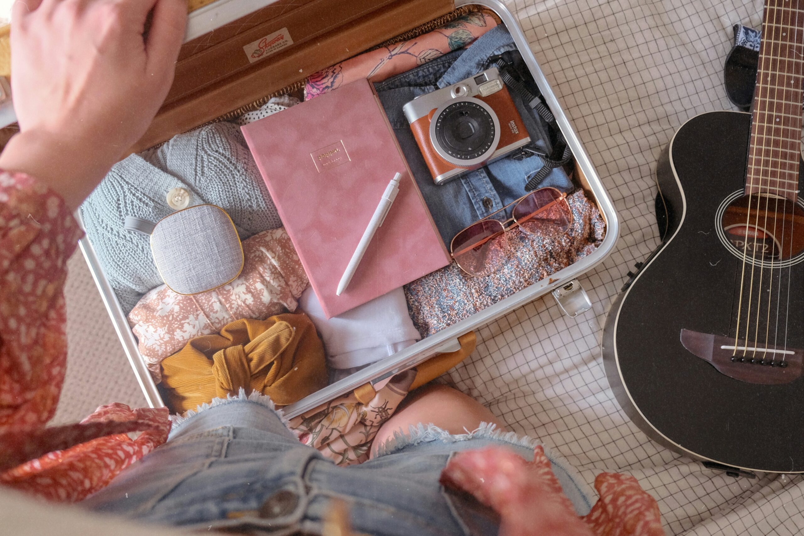 An open suitcase packed for a family trip