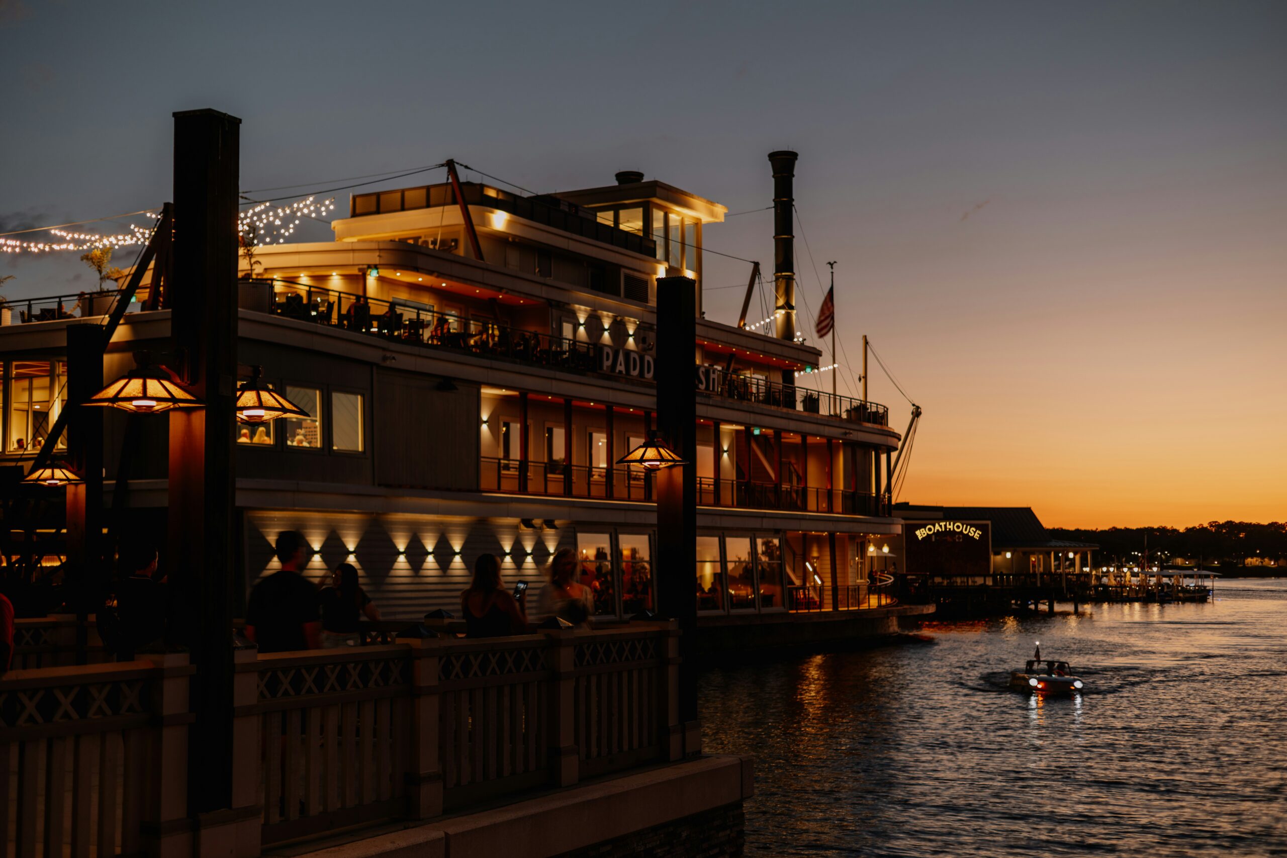 A riverboat restaurant on the water at Disney Springs at sunset