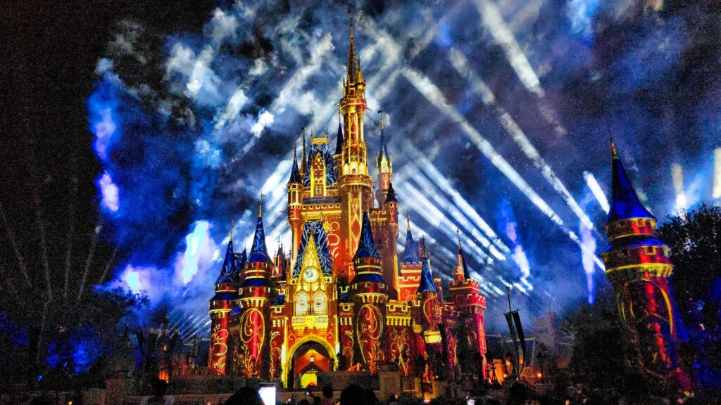 Cinderella Castle lit blue with searchlights at night, Magic Kingdom